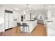 This open kitchen offers a center island, modern appliances, and hardwood floors at 96 Glenmoor Ln, Cherry Hills Village, CO 80113