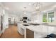 Spacious kitchen with white cabinets, large island, and stainless steel appliances at 96 Glenmoor Ln, Cherry Hills Village, CO 80113