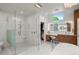 Bright bathroom offers a glass shower, vanity area, and walk-in closet access at 96 Glenmoor Ln, Cherry Hills Village, CO 80113