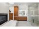 A luxurious bathroom featuring a fireplace, soaking tub, and a spacious walk-in shower at 96 Glenmoor Ln, Cherry Hills Village, CO 80113