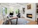 Bright office space featuring large windows, custom built-ins, a modern fireplace, and coffered ceilings at 96 Glenmoor Ln, Cherry Hills Village, CO 80113