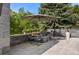 Charming outdoor patio with a fire pit, comfortable seating, and a stylish umbrella for relaxing evenings at 96 Glenmoor Ln, Cherry Hills Village, CO 80113