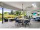 Charming outdoor patio with a fireplace, seating area, and lush greenery for outdoor enjoyment and relaxation at 96 Glenmoor Ln, Cherry Hills Village, CO 80113