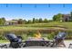 Relaxing patio area with a fire pit and comfortable seating overlooking the golf course and beautiful landscaping at 96 Glenmoor Ln, Cherry Hills Village, CO 80113