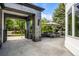 Stone patio area with built in seating, a fire pit, umbrella and mature trees at 96 Glenmoor Ln, Cherry Hills Village, CO 80113