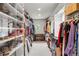 Spacious walk-in closet with custom shelving and storage for clothes and shoes at 96 Glenmoor Ln, Cherry Hills Village, CO 80113