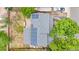 Aerial view of the roof with solar panels, backyard with patio, fire pit, fence, and covered area at 1758 S Tucson St, Aurora, CO 80012