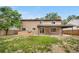 Exterior view of the back of the house with a covered patio and built-in outdoor grill at 1758 S Tucson St, Aurora, CO 80012
