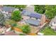 Aerial view of a home's backyard with patio, fire pit, fence, covered area, and solar panels on the roof at 1758 S Tucson St, Aurora, CO 80012