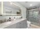 Updated bathroom with double vanity, illuminated mirror, and contemporary shower at 1758 S Tucson St, Aurora, CO 80012