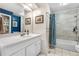 Bright bathroom features white vanity, a bathtub with a shower, and contemporary fixtures at 1758 S Tucson St, Aurora, CO 80012
