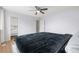 Bedroom featuring a bed, wood floors, closet, and minimalist decor at 1758 S Tucson St, Aurora, CO 80012
