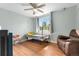 Bright bedroom featuring a daybed, ceiling fan, and a comfortable recliner at 1758 S Tucson St, Aurora, CO 80012
