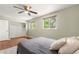 Bedroom features a ceiling fan, wood floors, closet, and serene green walls at 1758 S Tucson St, Aurora, CO 80012