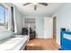 Bright bedroom with closet, single bed, and comfortable seating area at 1758 S Tucson St, Aurora, CO 80012