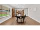 Bright dining area featuring a modern table, wood floors, large window and stylish furniture at 1758 S Tucson St, Aurora, CO 80012