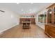 Dining room with modern table and chairs, accent brick wall with fireplace, and view to side yard at 1758 S Tucson St, Aurora, CO 80012