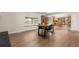 Dining room with modern table and chairs, view of kitchen, and hardwood floors at 1758 S Tucson St, Aurora, CO 80012