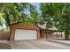 Charming brick and siding home with a two-car garage and well-manicured lawn at 1758 S Tucson St, Aurora, CO 80012