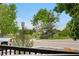 Neighborhood view with mature trees and open park space at 1758 S Tucson St, Aurora, CO 80012