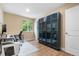 Well-lit office space with a large window, built-in shelving, and functional decor at 1758 S Tucson St, Aurora, CO 80012