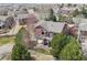 Aerial view of home with fenced yard, a deck area, and mature trees at 5810 Moss Ct, Golden, CO 80403