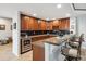 Basement bar area featuring granite counters, wine fridge, microwave, and barstool seating at 5810 Moss Ct, Golden, CO 80403