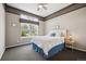 Cozy bedroom with large window, neutral walls, ceiling fan, and carpet flooring at 5810 Moss Ct, Golden, CO 80403