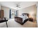 Comfortable bedroom with ceiling fan, carpet, and window with outside views at 5810 Moss Ct, Golden, CO 80403