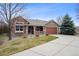 Charming ranch-style home featuring a covered front porch and attached two-car garage at 5810 Moss Ct, Golden, CO 80403