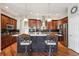 Modern kitchen featuring an island with seating, stainless steel appliances, and dark wood cabinetry at 5810 Moss Ct, Golden, CO 80403