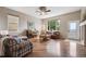 Comfortable living room featuring hardwood floors, ample natural light, and a cozy seating area at 5810 Moss Ct, Golden, CO 80403
