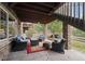 Covered patio with comfortable seating and stone pillars at 5810 Moss Ct, Golden, CO 80403