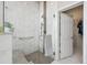 Modern shower with glass door, tile surround, and accessible grab bar at 5810 Moss Ct, Golden, CO 80403
