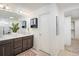 Bathroom featuring double sinks, large mirror, and ample cabinet storage at 9283 Sedalia St, Commerce City, CO 80022