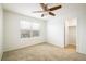 Well-lit bedroom featuring carpet flooring, a ceiling fan, and a window with neighborhood views at 9283 Sedalia St, Commerce City, CO 80022