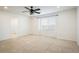 Bedroom with neutral carpet, ceiling fan, and a bright window at 9283 Sedalia St, Commerce City, CO 80022