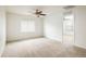 Bright bedroom with carpet flooring, a ceiling fan, and a window providing natural light at 9283 Sedalia St, Commerce City, CO 80022
