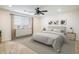 Serene bedroom with neutral colors, a ceiling fan, and a large window with blinds at 9283 Sedalia St, Commerce City, CO 80022