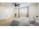 Bright bedroom featuring neutral colors, a ceiling fan, and a large window with blinds at 9283 Sedalia St, Commerce City, CO 80022