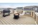 Cozy outdoor deck featuring a grill, fire pit, and seating, perfect for entertaining at 9283 Sedalia St, Commerce City, CO 80022