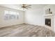 Bright living room with wood floors, large window, and cozy fireplace at 9283 Sedalia St, Commerce City, CO 80022