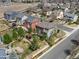 Aerial view of a home with a manicured lawn, a cozy deck, a charming gazebo, surrounded by green trees at 10273 Salida St, Commerce City, CO 80022