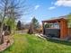 Serene backyard featuring a hot tub under a pergola, a teepee, lush lawn, and meticulously landscaped borders at 10273 Salida St, Commerce City, CO 80022