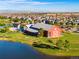 Aerial view of a spacious community center with adjacent pool and play area near a pond at 10273 Salida St, Commerce City, CO 80022