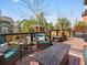 Inviting outdoor deck with comfortable seating, a fire pit, and views of the landscaped backyard and charming gazebo at 10273 Salida St, Commerce City, CO 80022