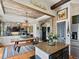Cozy dining room with a rustic table, decorative chandelier, wood beams, and stone accent wall at 10273 Salida St, Commerce City, CO 80022