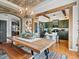 Open dining room and kitchen featuring custom lighting, wood floors, and a spacious kitchen island at 10273 Salida St, Commerce City, CO 80022