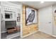Hallway featuring a stylish wood accent wall with an owl print adjacent to a modern bathroom at 10273 Salida St, Commerce City, CO 80022