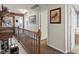 Bright hallway with wood accents, patterned carpet, and decorative artwork on the walls at 10273 Salida St, Commerce City, CO 80022